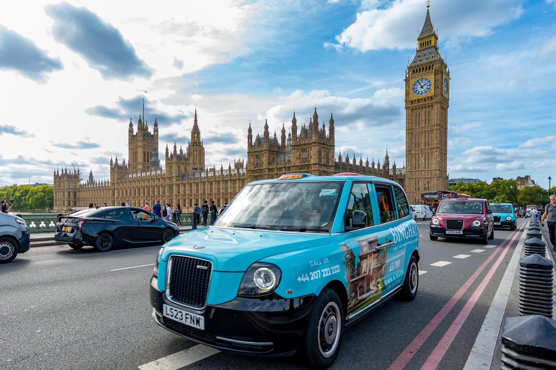 Taxi in turquoise Binghatti livery on Westminster Bridge