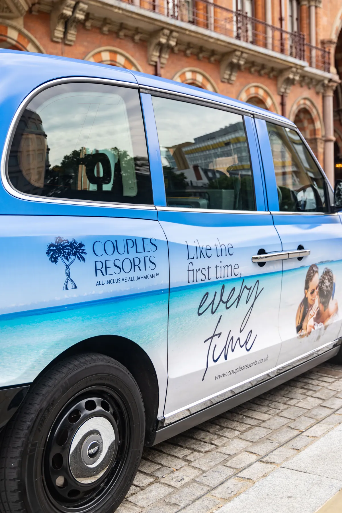 Close-up of a taxi in Couples Resorts livery reading “Like the first time, every time”